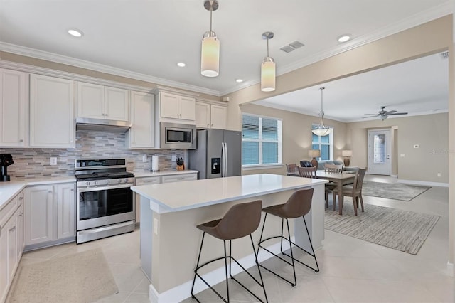 kitchen featuring white cabinetry, ceiling fan, a kitchen island, and appliances with stainless steel finishes