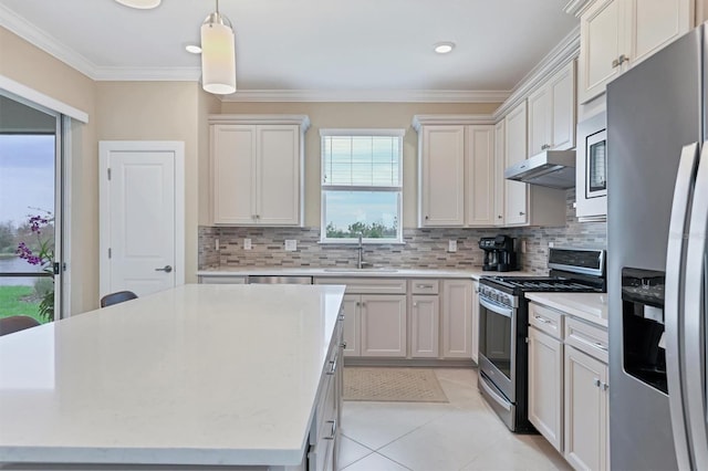 kitchen with backsplash, stainless steel appliances, sink, light tile patterned floors, and hanging light fixtures