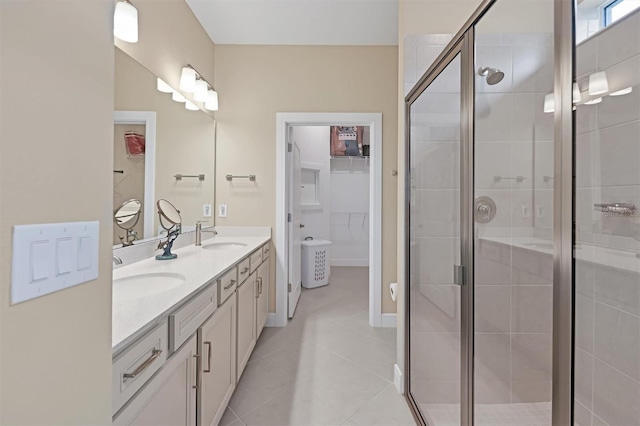 bathroom featuring vanity, tile patterned floors, and a shower with door