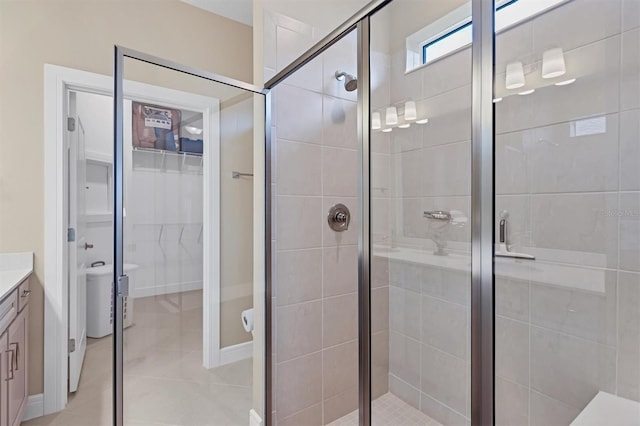 bathroom with tile patterned flooring, vanity, and an enclosed shower