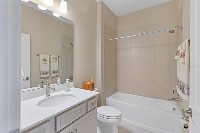 full bathroom with vanity, toilet, and tiled shower / bath combo