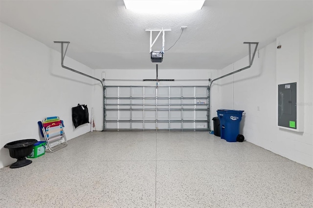 garage with electric panel and a garage door opener