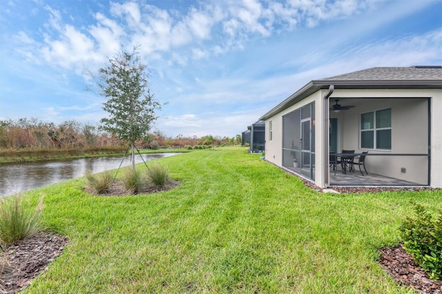 view of yard with a patio and a water view