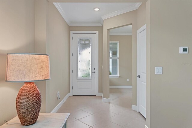 foyer entrance with light tile patterned floors and ornamental molding