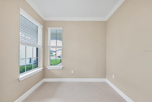 spare room with ornamental molding and light tile patterned flooring