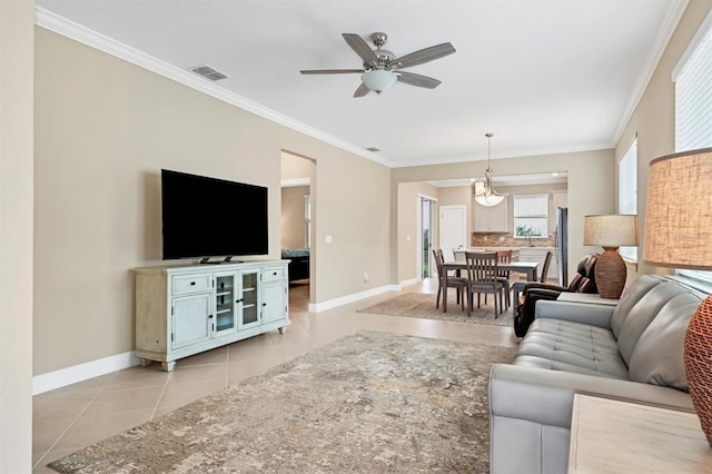 tiled living room featuring ceiling fan and ornamental molding