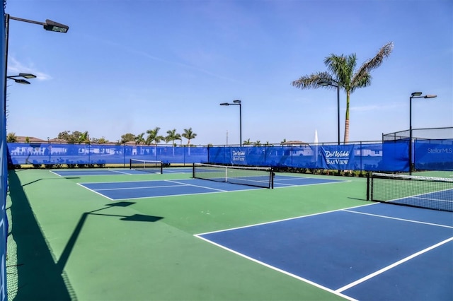 view of tennis court featuring basketball court