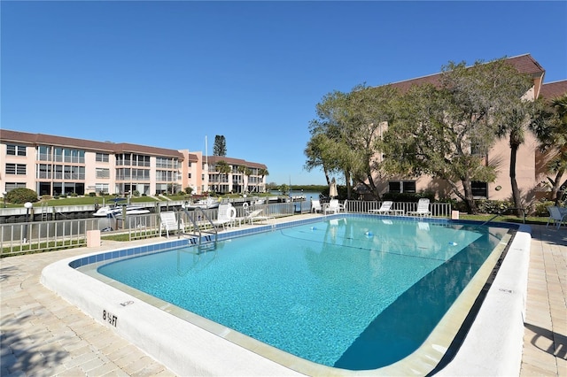 view of swimming pool featuring a water view