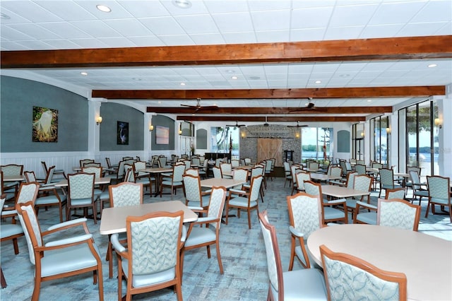 4380 Exeter Dr Unit 303, Longboat Key, FL 34228 - dining area with beam ceiling, a wainscoted wall, and recessed lighting