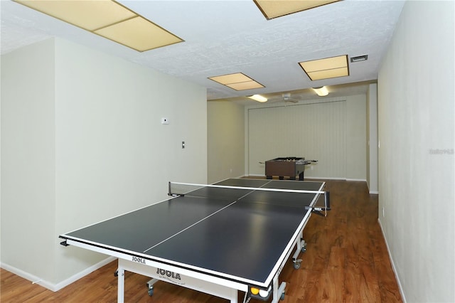 playroom featuring a textured ceiling and dark hardwood / wood-style flooring