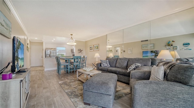 living room with hardwood / wood-style floors and ornamental molding