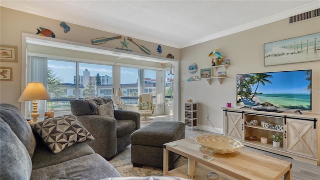 4380 Exeter Dr Unit 303, Longboat Key, FL 34228 - living room with ornamental molding, a textured ceiling, baseboards, and light wood finished floors