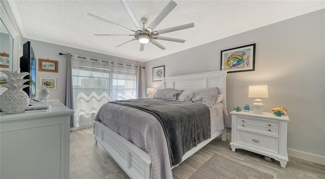 bedroom with ceiling fan, a textured ceiling, and crown molding