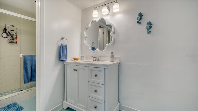 bathroom with vanity and tiled shower