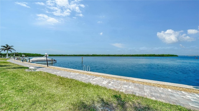 dock area featuring a yard and a water view