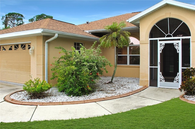 view of exterior entry with a garage