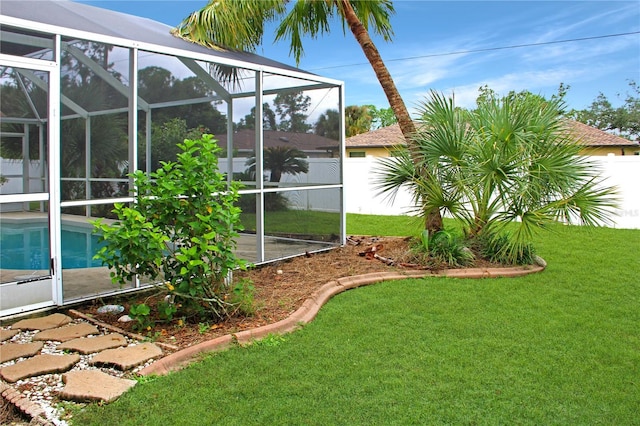 view of yard with a fenced in pool and glass enclosure