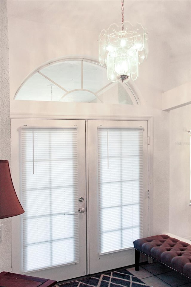 entryway featuring french doors and a notable chandelier