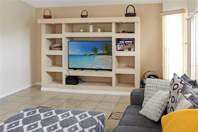 living room featuring built in shelves and light tile patterned floors