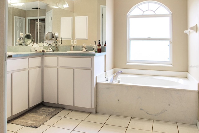 bathroom with tile patterned floors, a bathtub, and vanity