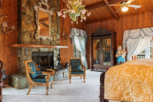 bedroom with carpet flooring, wooden walls, a fireplace, and wooden ceiling