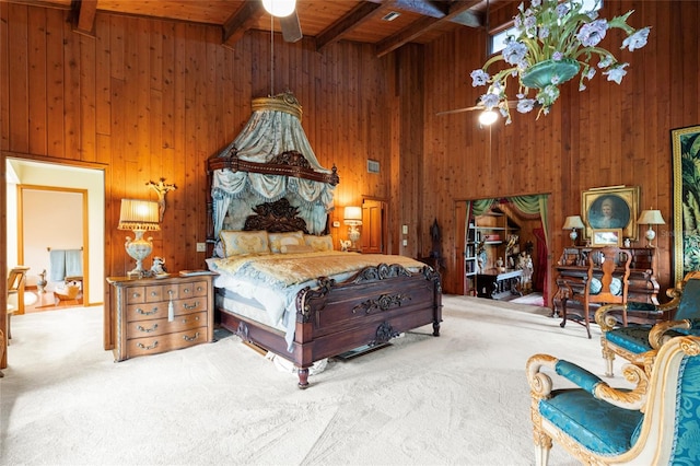 bedroom with carpet flooring, ceiling fan, wooden walls, beam ceiling, and a high ceiling