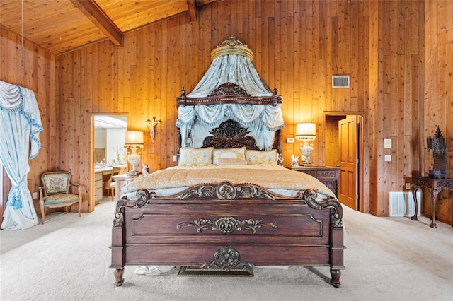 carpeted bedroom with high vaulted ceiling, wooden walls, connected bathroom, beam ceiling, and wood ceiling