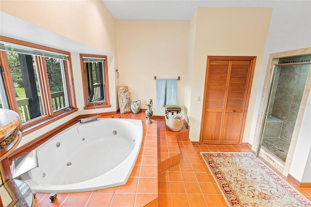 bathroom featuring separate shower and tub, tile patterned floors, and a high ceiling