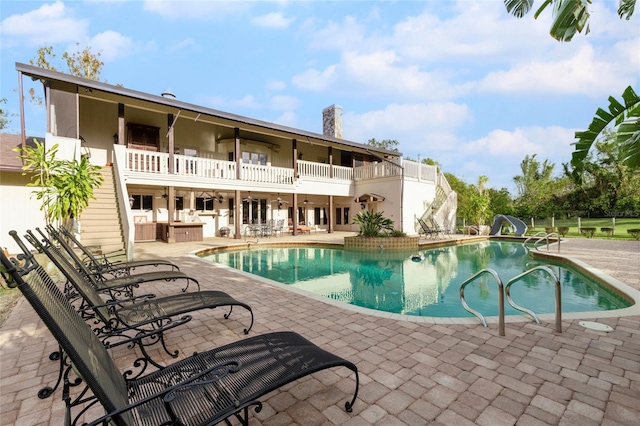 view of pool featuring a patio and a water slide