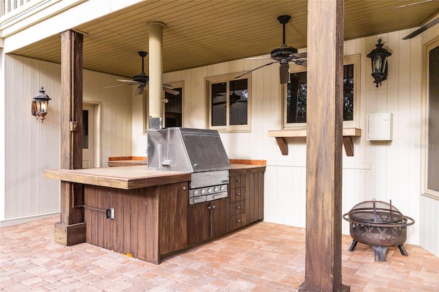 view of patio with grilling area, area for grilling, an outdoor fire pit, and ceiling fan