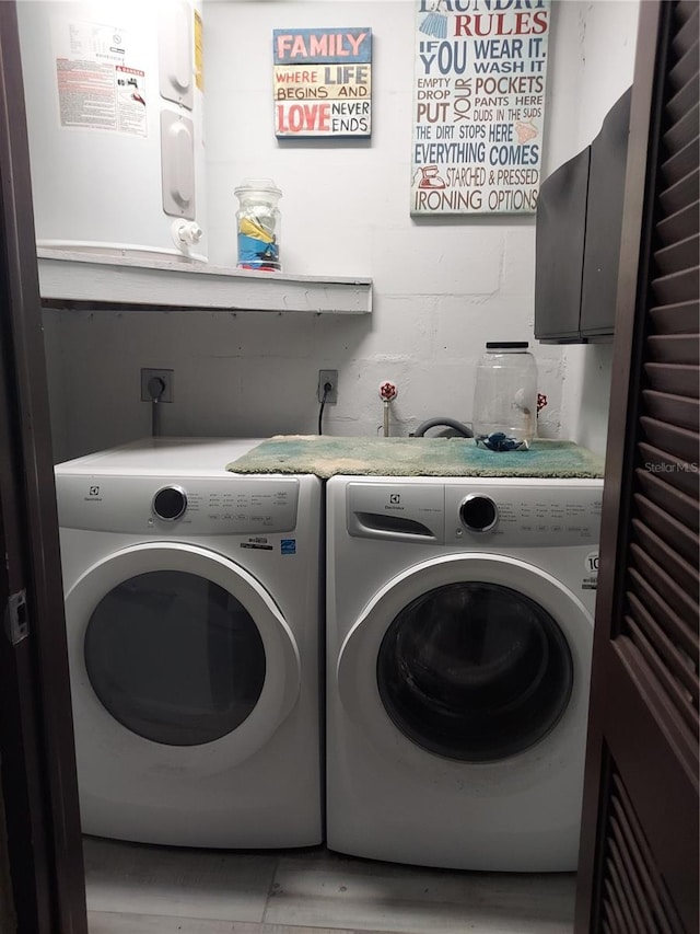 laundry room with cabinets and washer and dryer