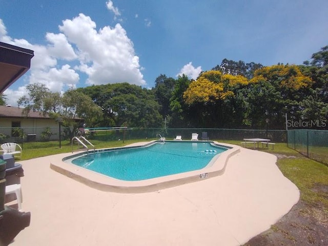 view of swimming pool featuring a patio area