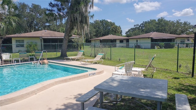 view of pool with a yard and a patio area