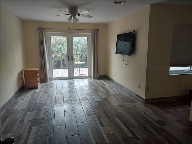 spare room with ceiling fan, french doors, and dark hardwood / wood-style flooring