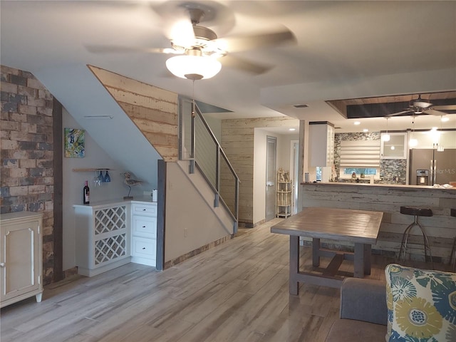 living room with light hardwood / wood-style flooring and ceiling fan