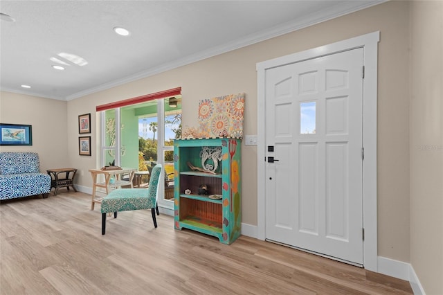 entryway featuring light hardwood / wood-style floors and crown molding