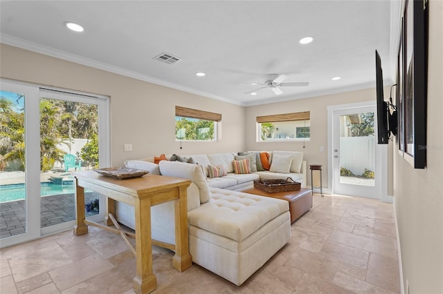 living room with ceiling fan and crown molding