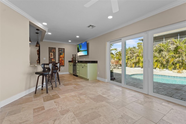 bar with ceiling fan, crown molding, pendant lighting, wine cooler, and green cabinets