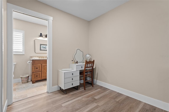 office area with light hardwood / wood-style floors