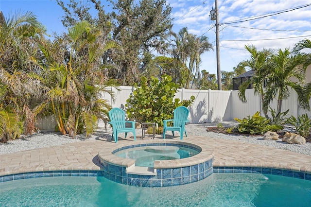 view of pool featuring an in ground hot tub