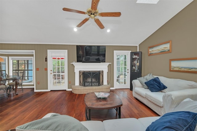 living room with lofted ceiling, dark wood-type flooring, a fireplace, and ceiling fan