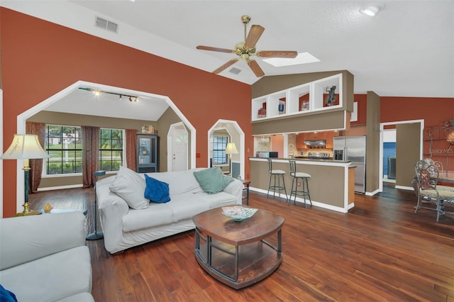 living room with vaulted ceiling, dark wood-type flooring, and ceiling fan