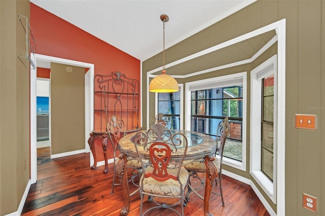 dining space with lofted ceiling and dark wood-type flooring