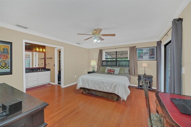 bedroom with crown molding, ceiling fan, hardwood / wood-style floors, and a textured ceiling