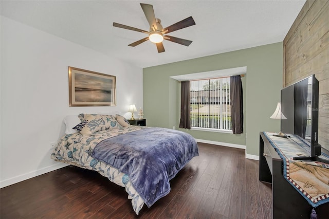 bedroom with dark hardwood / wood-style floors and ceiling fan