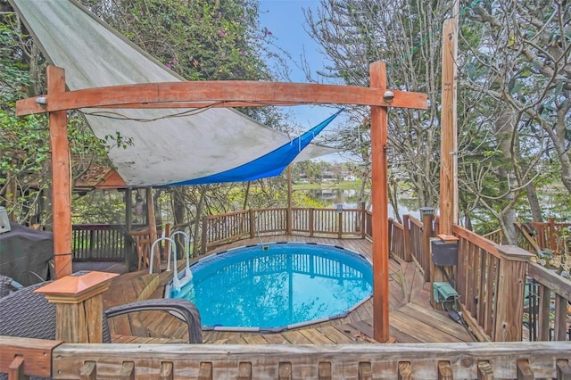 view of swimming pool with a deck with water view