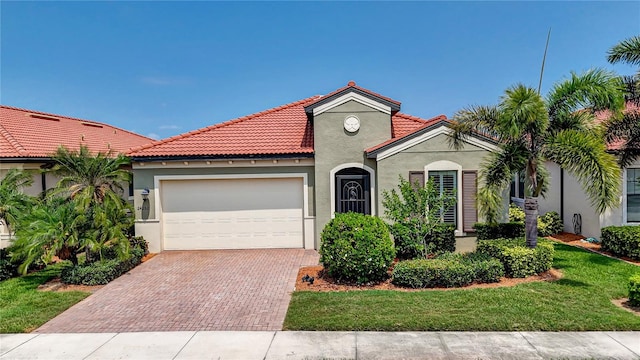 mediterranean / spanish-style house with a garage and a front yard