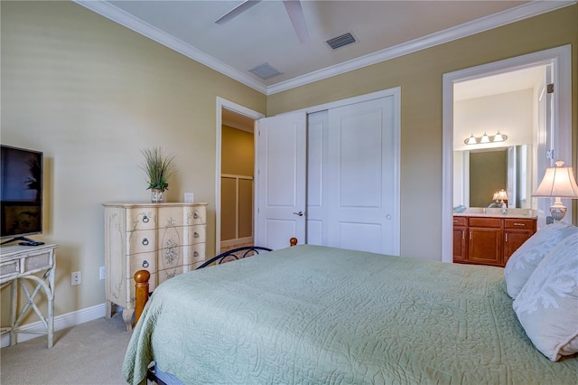 carpeted bedroom featuring a closet, crown molding, connected bathroom, and ceiling fan