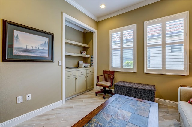 sitting room with crown molding and light hardwood / wood-style flooring