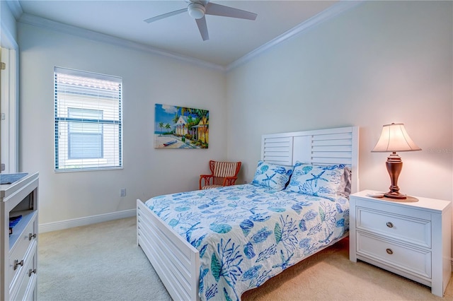 carpeted bedroom with ceiling fan and ornamental molding